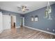 Bedroom featuring laminate floors, a ceiling fan, and a barn door at 1009 Hopscotch Ln., Conway, SC 29526