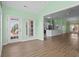 Open-concept living and dining area with hardwood flooring and abundant natural light at 1009 Hopscotch Ln., Conway, SC 29526
