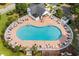 A stunning in-ground community pool surrounded by chairs and tables for residents to enjoy in the Carolina sun at 1009 Hopscotch Ln., Conway, SC 29526