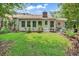 Well maintained backyard with green grass, mature trees, and patio seating area at 103 Robin Ct., Murrells Inlet, SC 29576