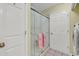 Well lit bathroom showcasing the shower stall and a matching washer and dryer unit at 103 Robin Ct., Murrells Inlet, SC 29576