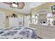 Bright bedroom with white furniture, a patterned bedspread, and a decorative mirror at 103 Robin Ct., Murrells Inlet, SC 29576
