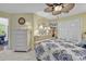 Airy bedroom featuring french doors, white furniture, and patterned blue bedding with a ceiling fan at 103 Robin Ct., Murrells Inlet, SC 29576