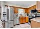 Functional kitchen featuring stainless steel appliances, wood cabinets, and tile flooring at 103 Robin Ct., Murrells Inlet, SC 29576