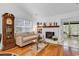 Cozy living room featuring a white brick fireplace, hardwood floors, and comfortable seating at 103 Robin Ct., Murrells Inlet, SC 29576