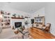 Bright living room featuring a cozy fireplace, hardwood floors, and comfortable furnishings at 103 Robin Ct., Murrells Inlet, SC 29576