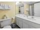 Well-lit bathroom with a single sink vanity, mirror, toilet, and a bathtub with shower at 1207 S Ocean Blvd. # 51001, Myrtle Beach, SC 29577