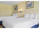 Hotel suite featuring two comfy queen beds, artwork, and nice lighting at 1207 S Ocean Blvd. # 51001, Myrtle Beach, SC 29577