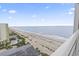 Expansive beach view from a condo balcony featuring ocean, beach, and a pool at 1207 S Ocean Blvd. # 51312, Myrtle Beach, SC 29577