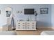 A bedroom showcases a dresser with a TV, accent chair and beach-themed decor at 1207 S Ocean Blvd. # 51312, Myrtle Beach, SC 29577