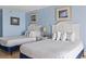 Cozy bedroom featuring two beds, soft lighting, and beach themed decor at 1207 S Ocean Blvd. # 51312, Myrtle Beach, SC 29577