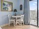A cozy dining area with seating for three and balcony access at 1207 S Ocean Blvd. # 51312, Myrtle Beach, SC 29577