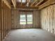 Bedroom under construction with visible framing, insulation, and windows overlooking the lake at 123 Westfield Circle, Conway, SC 29526