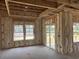 Bright interior view showcasing framed walls with insulation, large windows, and a sliding glass door, creating a customizable space at 123 Westfield Circle, Conway, SC 29526