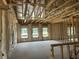 Spacious living room under construction with visible framing, insulation, and multiple windows at 123 Westfield Circle, Conway, SC 29526