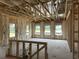Spacious living room under construction with visible framing, insulation, and multiple windows at 123 Westfield Circle, Conway, SC 29526