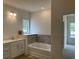 Bathroom featuring tub with tile surround and modern vanity at 126 Westfield Circle, Conway, SC 29526