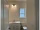 Bathroom with white vanity, modern fixtures, and a large window for natural light at 126 Westfield Circle, Conway, SC 29526
