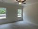 Spacious bedroom with ceiling fan and natural light from two large windows at 126 Westfield Circle, Conway, SC 29526