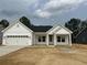 Charming one-story home with white siding, black roof, attached garage, and well-maintained landscaping at 126 Westfield Circle, Conway, SC 29526