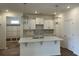 Open-concept kitchen with white cabinets, herringbone backsplash, quartz countertops, and modern pendant lighting at 126 Westfield Circle, Conway, SC 29526
