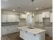 Modern kitchen featuring white cabinetry, herringbone backsplash, and a central island with quartz countertop at 126 Westfield Circle, Conway, SC 29526
