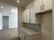 Stylish kitchen featuring white cabinets, sleek hardware, herringbone backsplash, and quartz countertops at 126 Westfield Circle, Conway, SC 29526