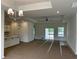 Spacious living room boasts modern lighting, tray ceiling with fan, and sliding glass doors to the outdoor space at 126 Westfield Circle, Conway, SC 29526