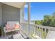 Relax on this balcony with scenic views of the water and lush greenery from the outdoor seating space at 131 Waypoint Ridge Ave. # Q26, Little River, SC 29566