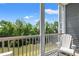 Enjoy serene water views from this cozy balcony with outdoor seating; the perfect spot to unwind and relax at 131 Waypoint Ridge Ave. # Q26, Little River, SC 29566