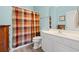 Well-lit bathroom with vanity, toilet, and shower with a patterned curtain at 131 Waypoint Ridge Ave. # Q26, Little River, SC 29566