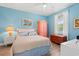 Cozy bedroom featuring pastel walls, wood accents, a bed with tropical pillows, and bright linens at 131 Waypoint Ridge Ave. # Q26, Little River, SC 29566