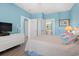 Bright bedroom featuring pastel walls, a TV on a white dresser, and wood flooring at 131 Waypoint Ridge Ave. # Q26, Little River, SC 29566
