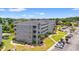 Aerial view of condo building with well-kept landscaping, lake, and parking at 131 Waypoint Ridge Ave. # Q26, Little River, SC 29566