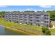 Apartment building exterior view with lush green lawn and pond at 131 Waypoint Ridge Ave. # Q26, Little River, SC 29566