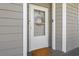 Front entrance with white door, wreath, light gray siding at 131 Waypoint Ridge Ave. # Q26, Little River, SC 29566