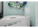 A practical laundry room featuring a washer, dryer, and storage shelves at 131 Waypoint Ridge Ave. # Q26, Little River, SC 29566