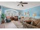 Bright living room with blue walls, neutral furniture, and a large window at 131 Waypoint Ridge Ave. # Q26, Little River, SC 29566