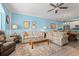 Comfortable living room with blue walls and neutral sofas. Open to kitchen at 131 Waypoint Ridge Ave. # Q26, Little River, SC 29566