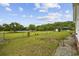 Fenced in backyard with mature landscaping, gravel area, and lake access at 1342 Highway 90, Conway, SC 29526