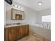 Bright bathroom featuring a vanity and a tub with a window at 1342 Highway 90, Conway, SC 29526