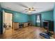 Open living room featuring hardwood floors, fireplace and bright turquoise walls at 1342 Highway 90, Conway, SC 29526