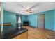 Inviting living room featuring hardwood floors, fireplace and bright turquoise walls at 1342 Highway 90, Conway, SC 29526