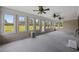 Covered porch with lots of windows and ceiling fans at 1342 Highway 90, Conway, SC 29526