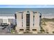 Aerial view of the condo building with beach access, parking, and clear ocean view at 1425 S Ocean Blvd. # 2A, North Myrtle Beach, SC 29582