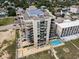 Aerial view of building showing balconies, rooftop solar panels, and swimming pool at 1425 S Ocean Blvd. # 2A, North Myrtle Beach, SC 29582
