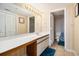 A well-lit bathroom with a large mirror, vanity with sink, and a separate toilet and shower area at 1425 S Ocean Blvd. # 2A, North Myrtle Beach, SC 29582