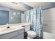 Relaxing bathroom with vanity, toilet and seashell themed shower curtain at 1425 S Ocean Blvd. # 2A, North Myrtle Beach, SC 29582