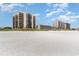 Wide sandy beach in front of multi-story condo buildings at 1425 S Ocean Blvd. # 2A, North Myrtle Beach, SC 29582