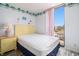 Cozy bedroom with palm tree border, seaside decor, and large window view at 1425 S Ocean Blvd. # 2A, North Myrtle Beach, SC 29582